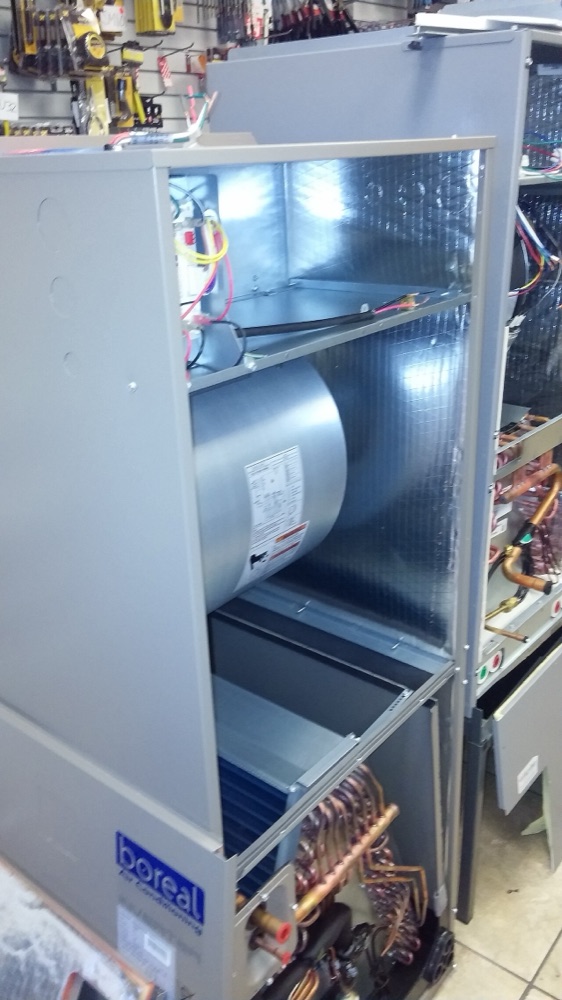 Rectangular sheet metal air conditioning ducts suspended below a ceiling
