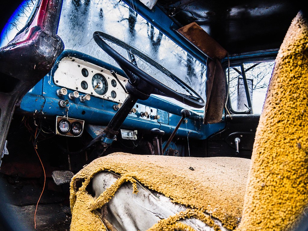Water-damaged pick-up truck seat with the fabric worn through to the foam underneath