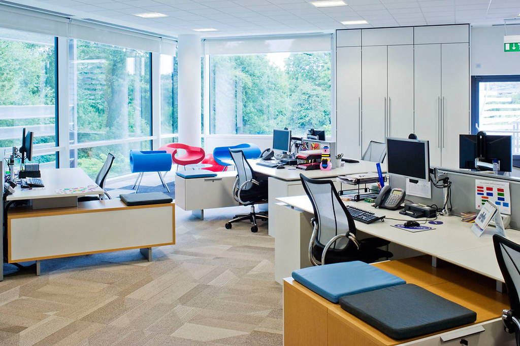 A modern open plan office with sealed windows, ceiling tiles and recessed lighting, the type of mechanically ventilated building that generates indoor air complaints